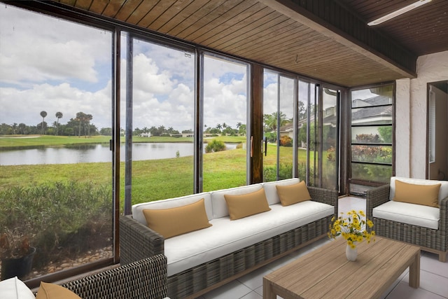 sunroom with a water view, outdoor lounge area, and plenty of natural light