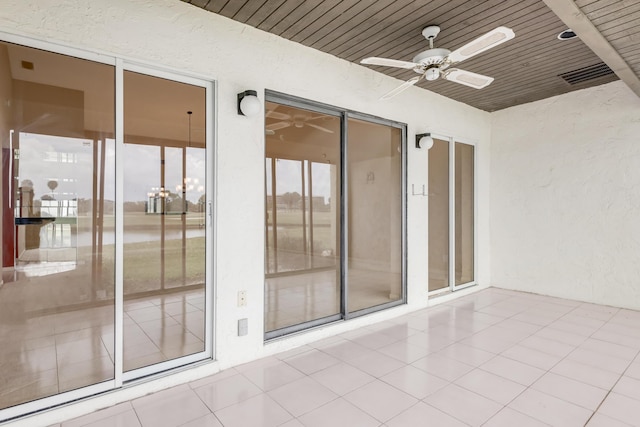 exterior space featuring a ceiling fan, a patio, and stucco siding