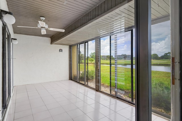unfurnished sunroom featuring a water view and a wealth of natural light