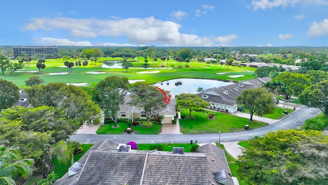 drone / aerial view with a water view and golf course view