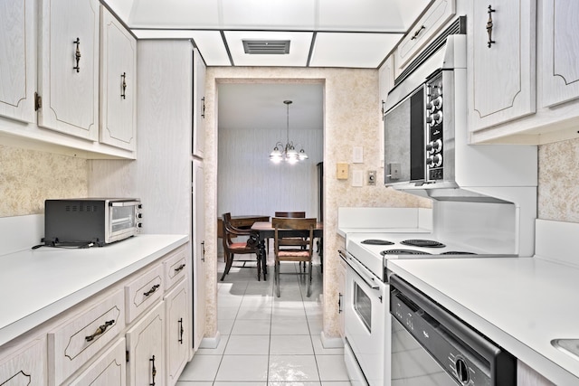 4810 NW 4th St Unit C, Delray Beach, FL 33445 - kitchen featuring visible vents, stainless steel microwave, dishwashing machine, a notable chandelier, and electric range