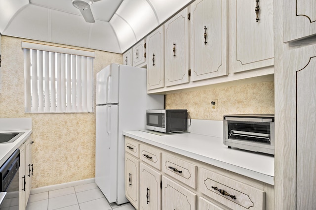 4810 NW 4th St Unit C, Delray Beach, FL 33445 - kitchen featuring stainless steel microwave, light tile patterned floors, a toaster, wallpapered walls, and dishwashing machine