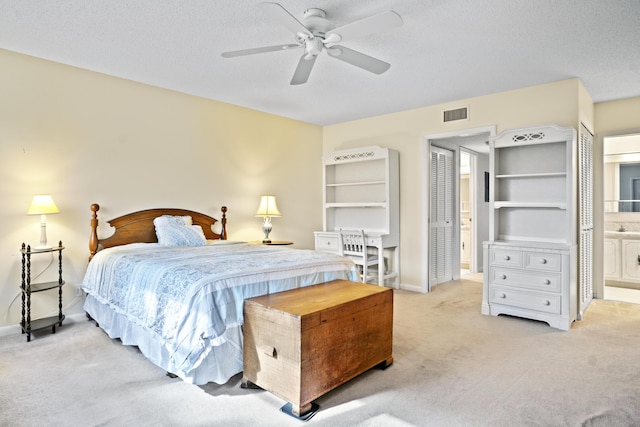 4810 NW 4th St Unit C, Delray Beach, FL 33445 - bedroom with carpet flooring, a textured ceiling, visible vents, baseboards, and connected bathroom