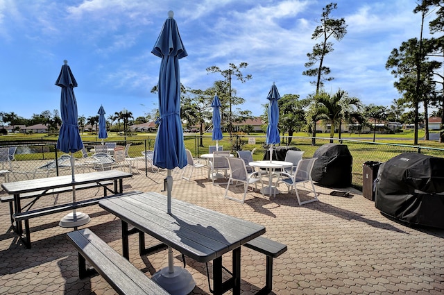 4810 NW 4th St Unit C, Delray Beach, FL 33445 - view of patio featuring outdoor dining area, fence, and a grill