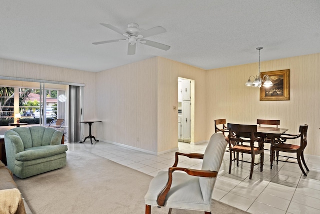 4810 NW 4th St Unit C, Delray Beach, FL 33445 - living area featuring baseboards, a textured ceiling, tile patterned floors, and ceiling fan with notable chandelier
