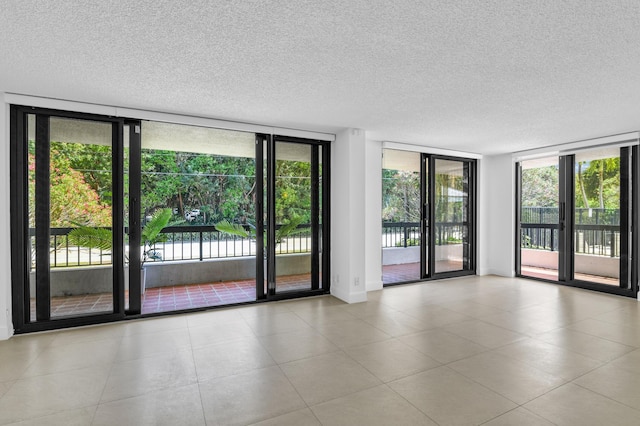 277 N Ocean Blvd Unit 1010, Boca Raton, FL 33432 - unfurnished room with floor to ceiling windows, a textured ceiling, healthy amount of natural light, and tile patterned floors