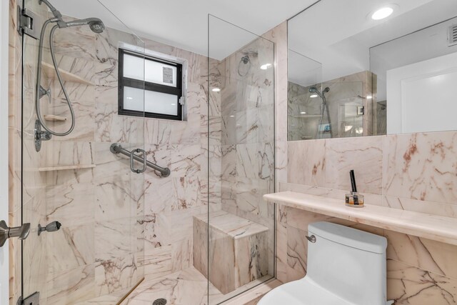 277 N Ocean Blvd Unit 1010, Boca Raton, FL 33432 - bathroom with toilet, a marble finish shower, and tile walls