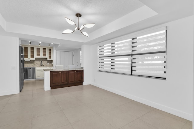277 N Ocean Blvd Unit 1010, Boca Raton, FL 33432 - kitchen with tasteful backsplash, stainless steel dishwasher, a textured ceiling, a sink, and freestanding refrigerator