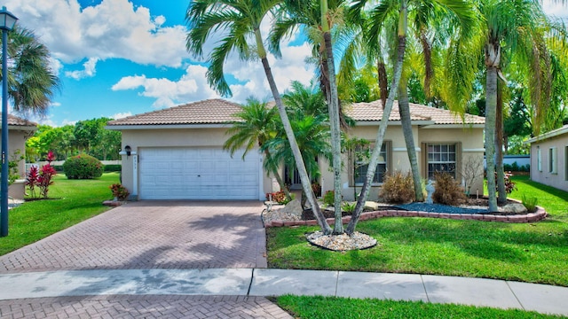 8353 Grand Messina Cir, Boynton Beach, FL 33472 - view of front facade featuring a tile roof, a front lawn, decorative driveway, and stucco siding