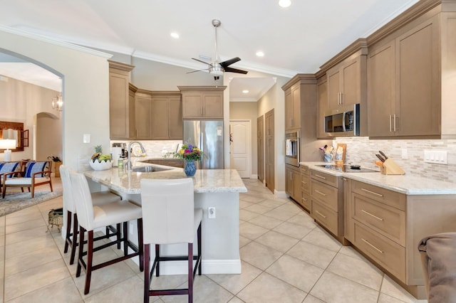 8353 Grand Messina Cir, Boynton Beach, FL 33472 - kitchen featuring arched walkways, a sink, appliances with stainless steel finishes, a ceiling fan, and a breakfast bar area