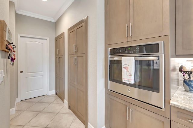 8353 Grand Messina Cir, Boynton Beach, FL 33472 - kitchen featuring crown molding, baseboards, oven, and light tile patterned flooring