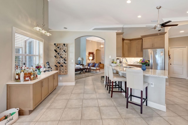 8353 Grand Messina Cir, Boynton Beach, FL 33472 - kitchen featuring arched walkways, stainless steel refrigerator with ice dispenser, a ceiling fan, a kitchen bar, and crown molding