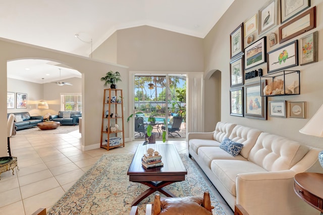8353 Grand Messina Cir, Boynton Beach, FL 33472 - living area featuring high vaulted ceiling, arched walkways, ornamental molding, light tile patterned flooring, and baseboards