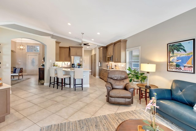 8353 Grand Messina Cir, Boynton Beach, FL 33472 - living area with crown molding, ceiling fan with notable chandelier, arched walkways, recessed lighting, and light tile patterned flooring