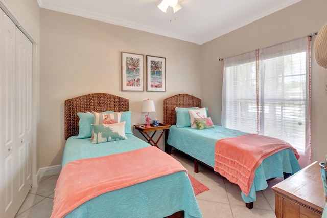 8353 Grand Messina Cir, Boynton Beach, FL 33472 - bedroom with a closet, light tile patterned flooring, baseboards, and ornamental molding