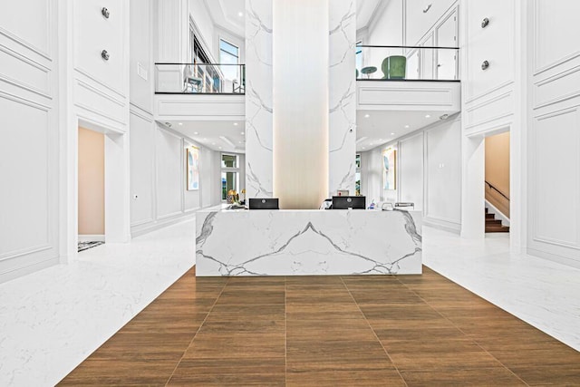 8353 Grand Messina Cir, Boynton Beach, FL 33472 - entrance foyer featuring a decorative wall, marble finish floor, a high ceiling, and stairs