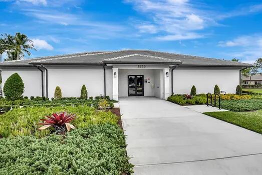 8353 Grand Messina Cir, Boynton Beach, FL 33472 - exterior space with concrete driveway, stucco siding, and french doors