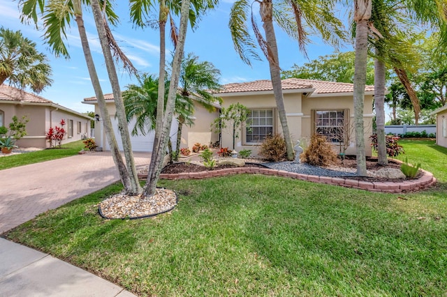 8353 Grand Messina Cir, Boynton Beach, FL 33472 - view of front facade featuring stucco siding, decorative driveway, a front lawn, a tile roof, and a garage
