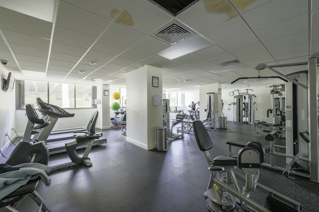 workout area with baseboards and a drop ceiling