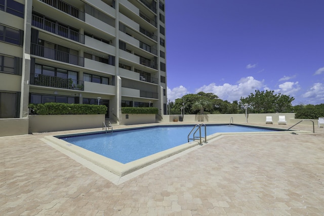 community pool with a patio area