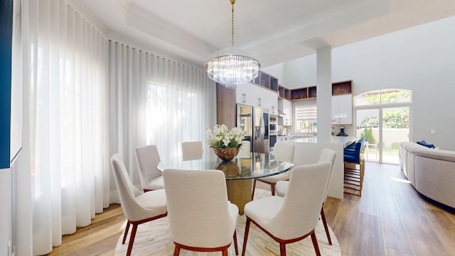 1942 NE 6th St, Deerfield Beach, FL 33441 - dining area with a tray ceiling, an inviting chandelier, and light wood-style floors