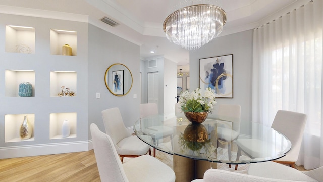 1942 NE 6th St, Deerfield Beach, FL 33441 - dining area featuring visible vents, an inviting chandelier, crown molding, and wood finished floors