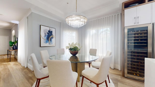 1942 NE 6th St, Deerfield Beach, FL 33441 - dining space featuring beverage cooler, crown molding, light wood-style flooring, and a chandelier