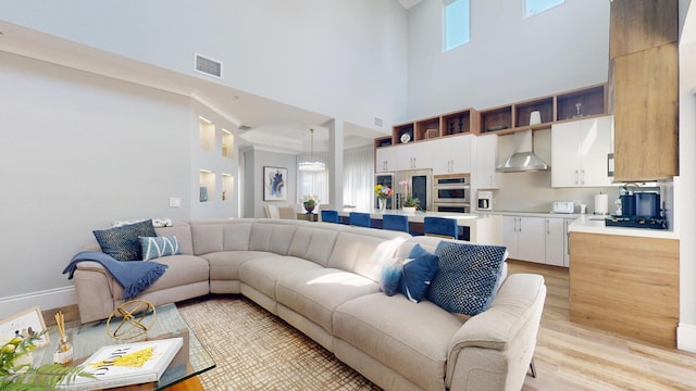 1942 NE 6th St, Deerfield Beach, FL 33441 - living area with baseboards, a towering ceiling, visible vents, and light wood finished floors