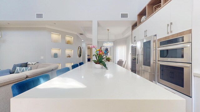 1942 NE 6th St, Deerfield Beach, FL 33441 - kitchen with open floor plan, visible vents, a kitchen island, and stainless steel appliances