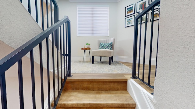 1942 NE 6th St, Deerfield Beach, FL 33441 - staircase with a textured wall, baseboards, and wood finished floors