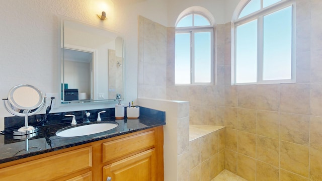 1942 NE 6th St, Deerfield Beach, FL 33441 - bathroom featuring vanity, a healthy amount of sunlight, and a walk in shower
