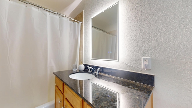 1942 NE 6th St, Deerfield Beach, FL 33441 - full bath with a shower with curtain, vanity, and a textured wall