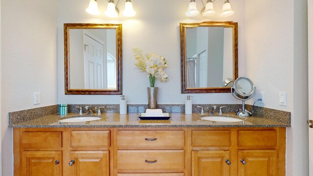 1942 NE 6th St, Deerfield Beach, FL 33441 - full bathroom with double vanity, a sink, and a notable chandelier