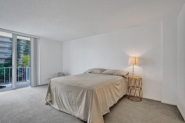 bedroom with floor to ceiling windows, carpet floors, a textured ceiling, access to outside, and baseboards