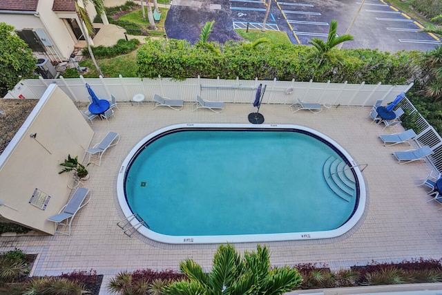 pool featuring fence and a patio area