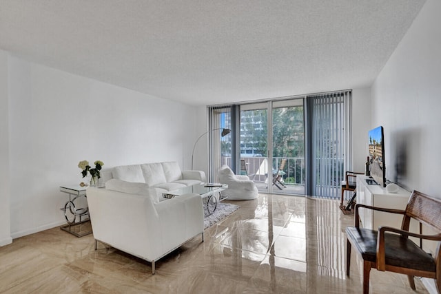 living room featuring floor to ceiling windows, baseboards, and a textured ceiling