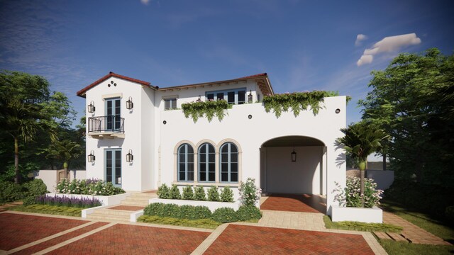 view of front of house with french doors, stucco siding, and a balcony