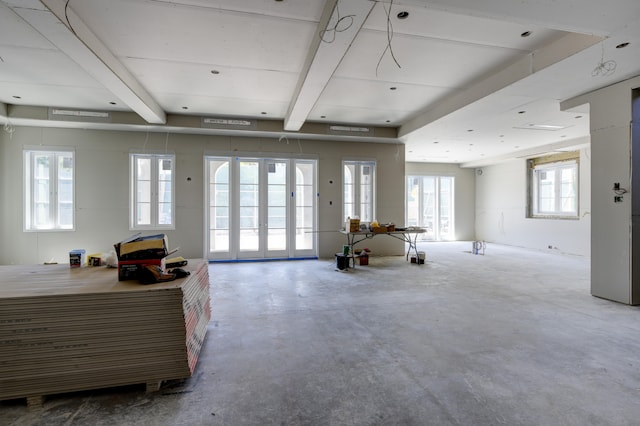 interior space featuring concrete floors and beamed ceiling