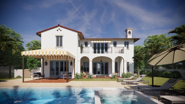 back of house featuring french doors, a balcony, a patio area, and an outdoor pool