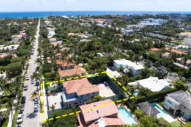 birds eye view of property with a water view and a residential view