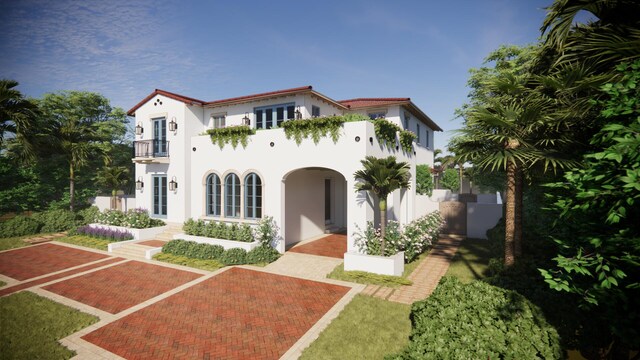 view of front of home featuring french doors, a balcony, and stucco siding
