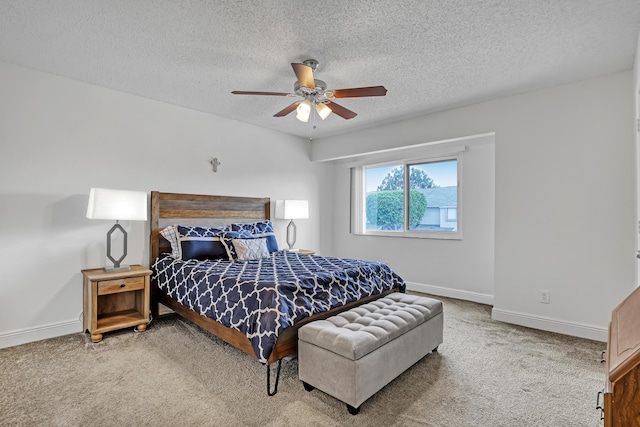 bedroom featuring carpet flooring, baseboards, ceiling fan, and a textured ceiling