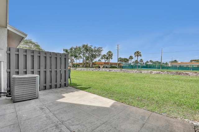 view of yard featuring central air condition unit, a water view, and a patio