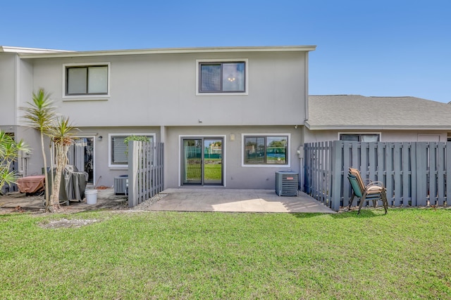 back of house with a patio area, cooling unit, stucco siding, fence, and a lawn