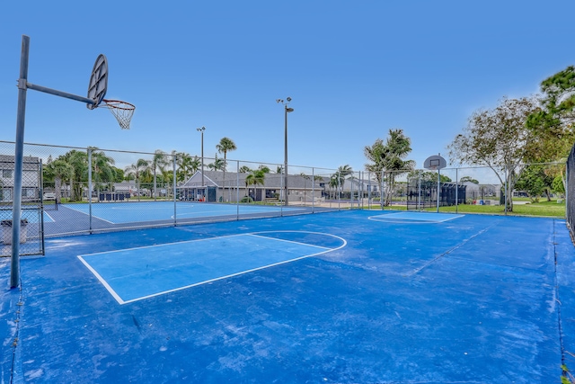 view of basketball court featuring community basketball court and fence
