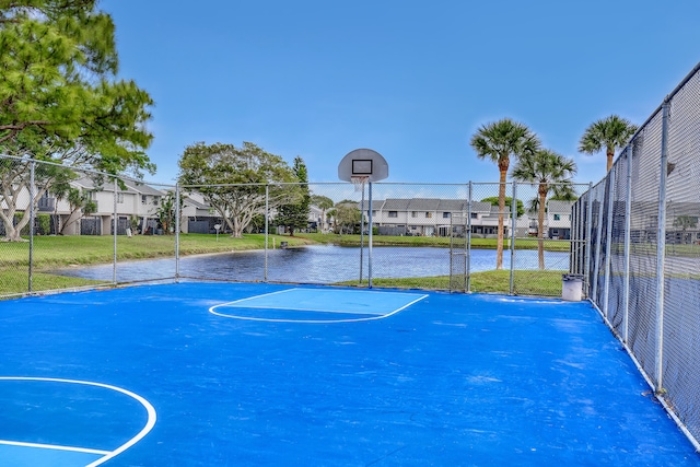 view of basketball court with community basketball court, fence, and a residential view