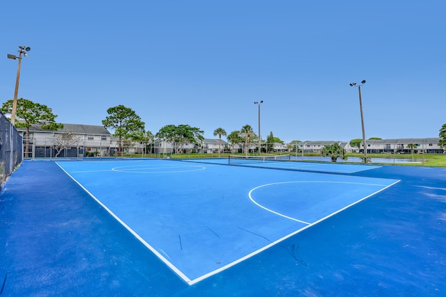 view of sport court featuring a residential view and fence