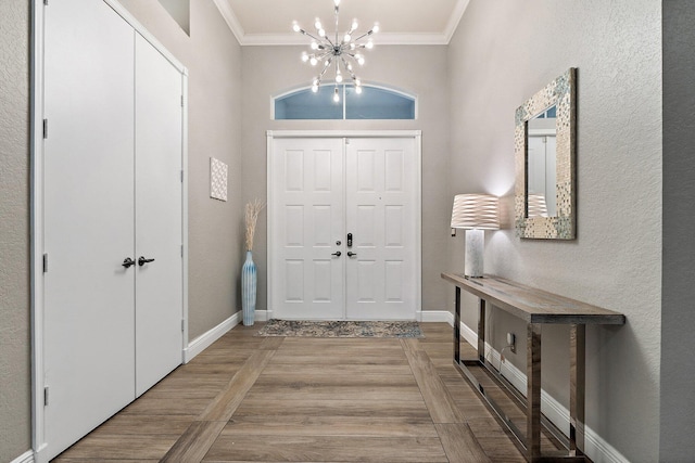 149 Sedona Way, Palm Beach Gardens, FL 33418 - foyer entrance with ornamental molding, a chandelier, and baseboards