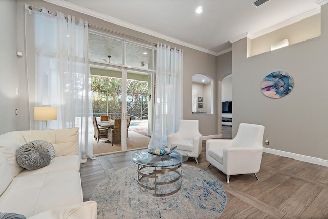 149 Sedona Way, Palm Beach Gardens, FL 33418 - living room featuring arched walkways, baseboards, ornamental molding, and wood finished floors