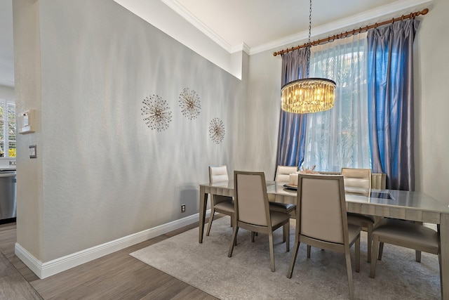 149 Sedona Way, Palm Beach Gardens, FL 33418 - dining space featuring a chandelier, baseboards, ornamental molding, and wood finished floors